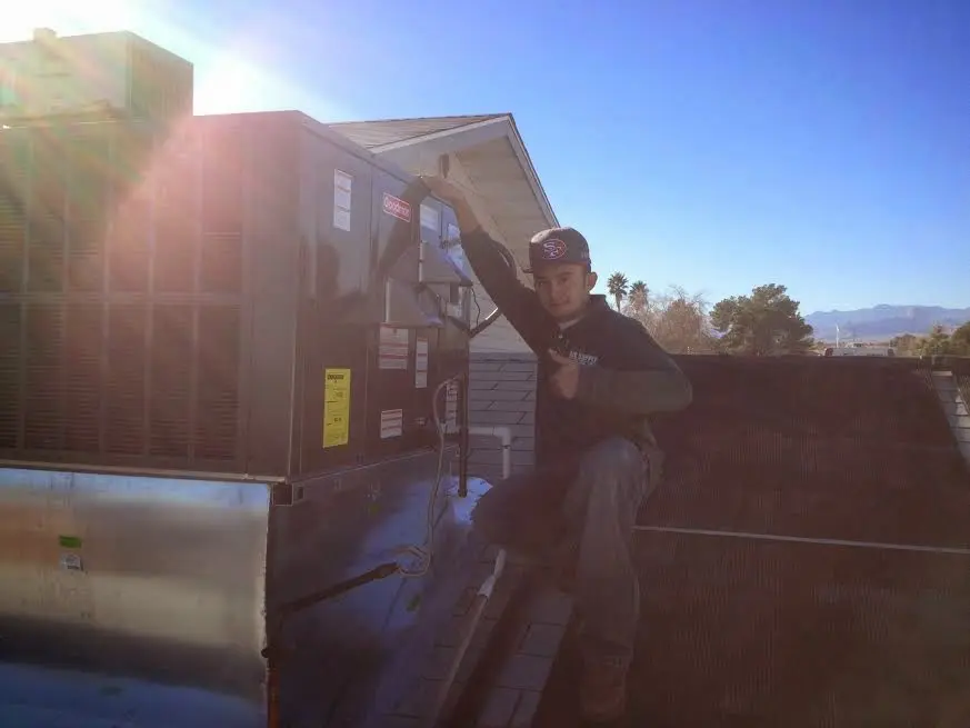 HVAC technician performing HVAC Inspection on a rooftop unit in Fairfield